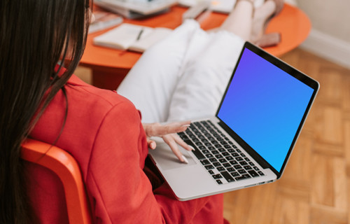 Woman holding a MacBook Pro mockup