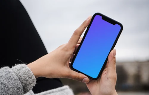 Woman holding a phone mockup in both hands