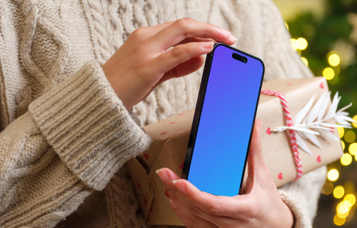 Woman holding a phone mockup in Christmas theme