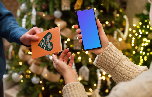 Woman holding a phone mockup while getting a gift card