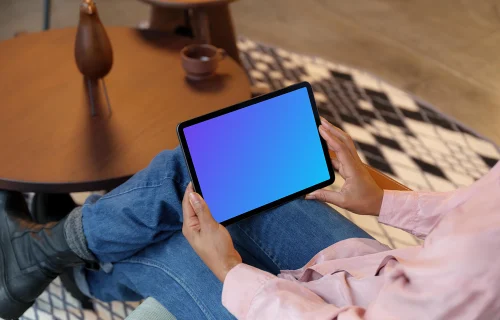Woman holding an iPad Air mockup
