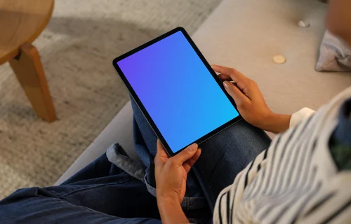 Woman holding an iPad Air mockup in cozy place