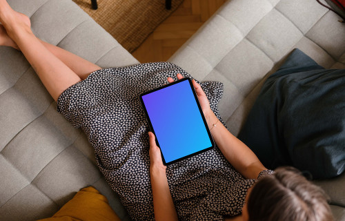 Woman holding an iPad Air mockup