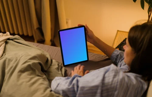 Woman holding an iPad mockup