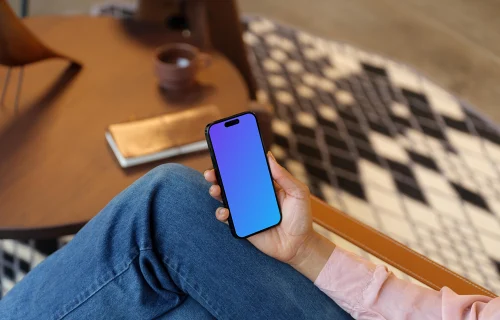 Woman holding an iPhone mockup