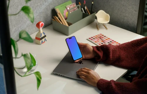 Free mockup of woman holding iPhone 14 Pro