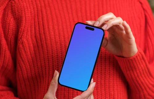 Woman in red sweater holding an iPhone 14 Pro mockup