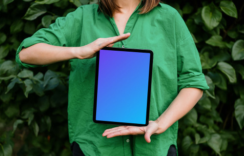 Woman showing off an iPad Air mockup in garden theme