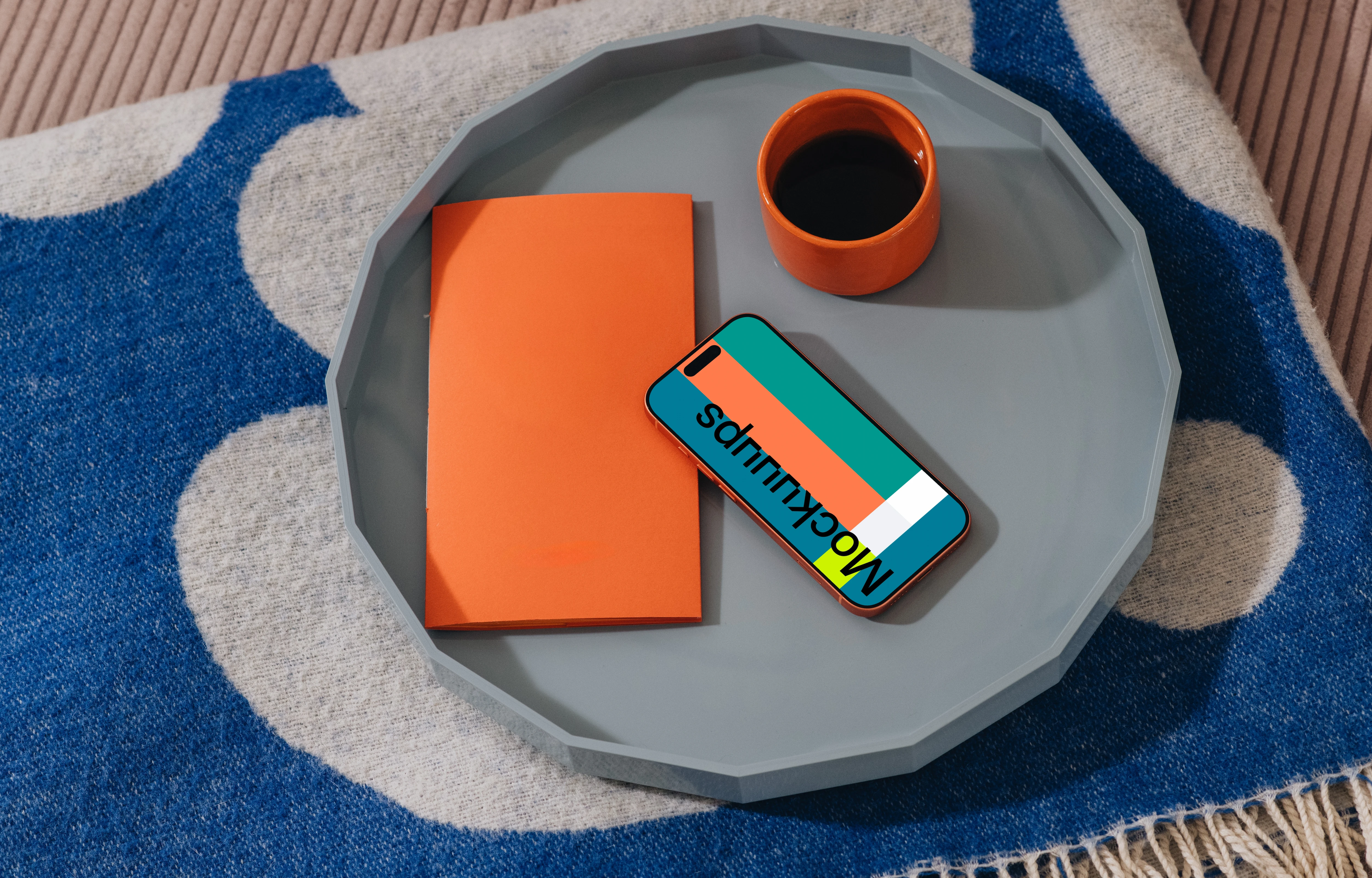 iPhone 17 Pro mockup on a tray with coffee and notebook