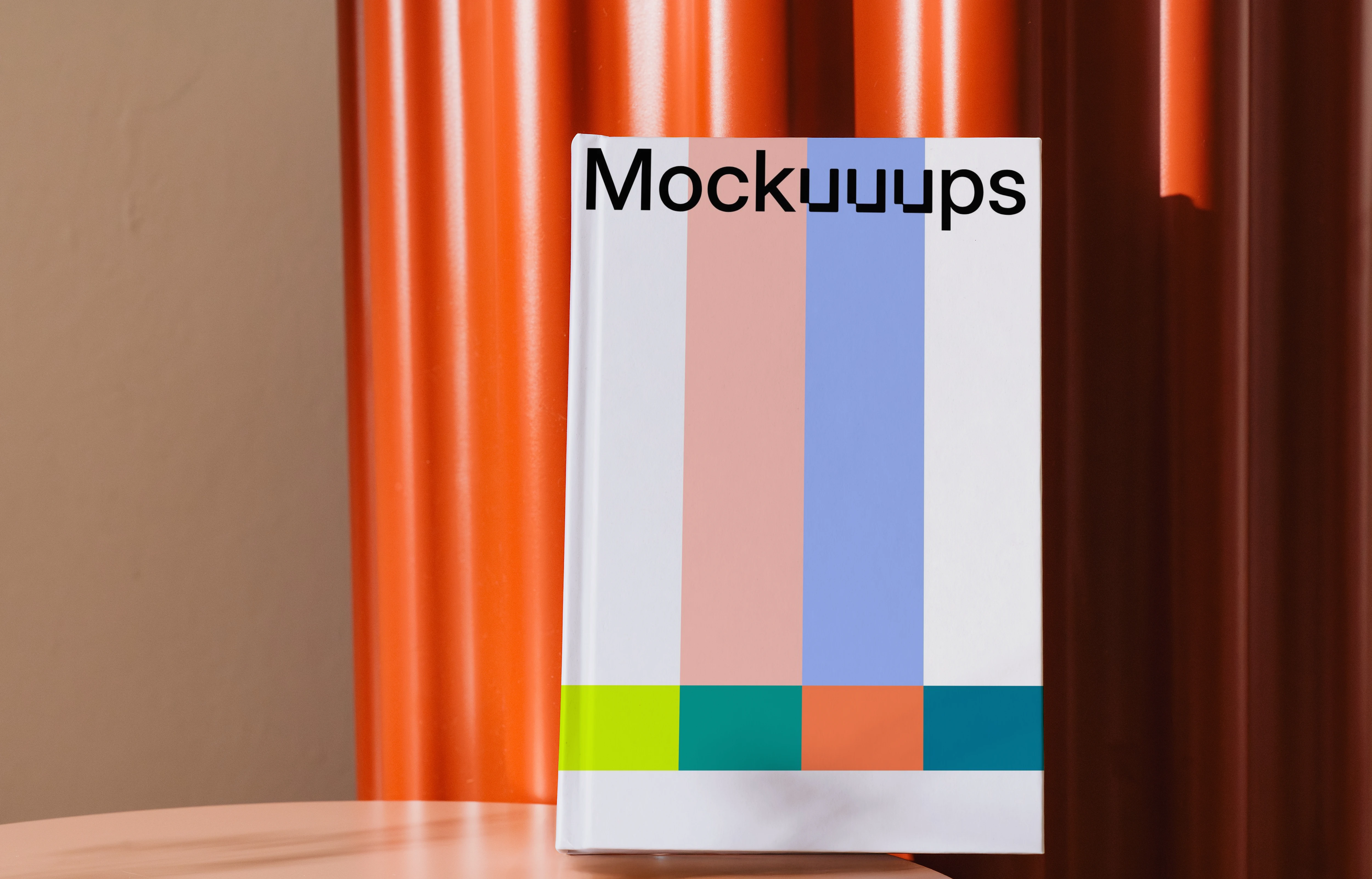 Book mockup on a round table with orange backdrop