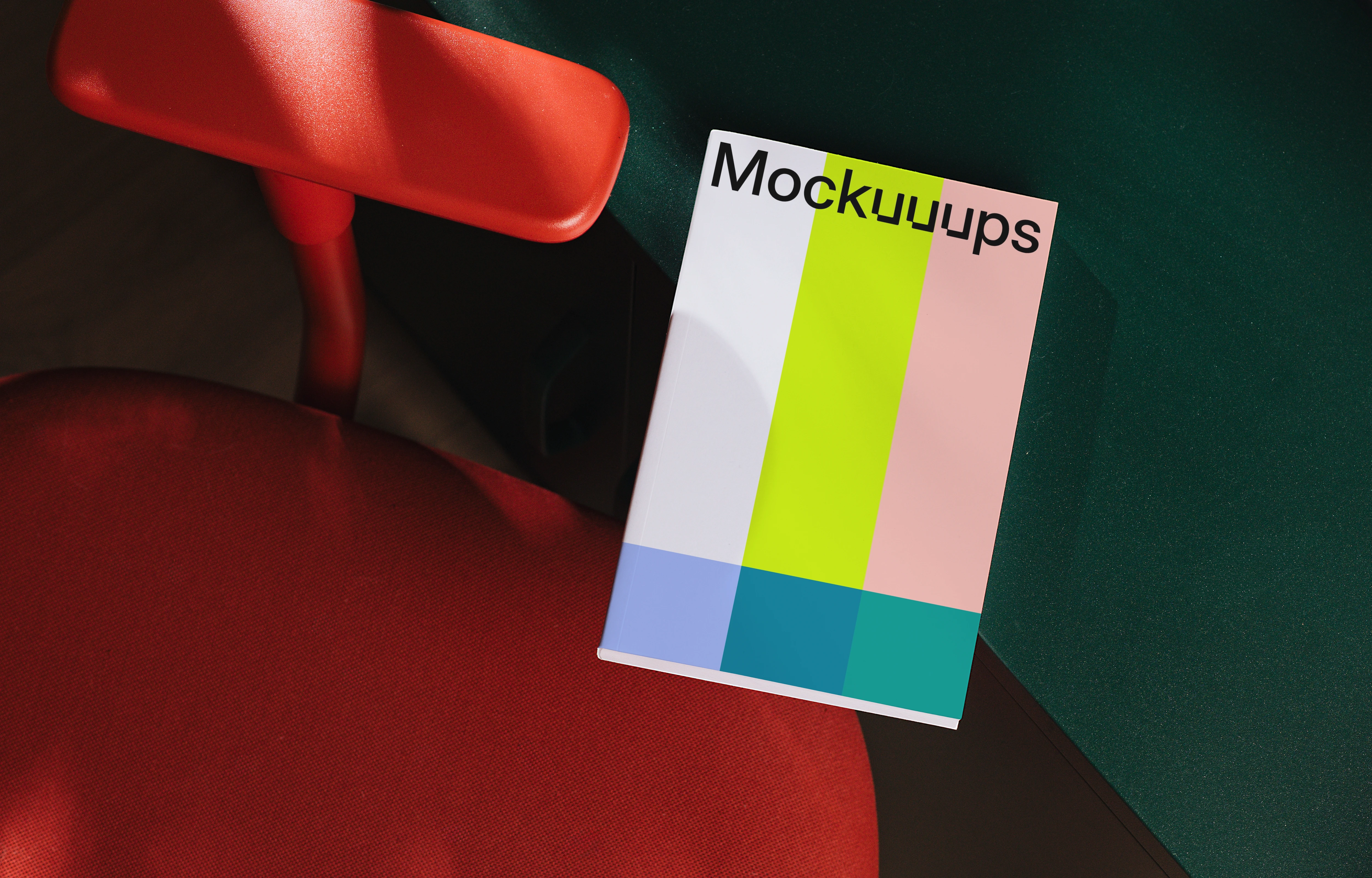 Book mockup on red chair with green desk