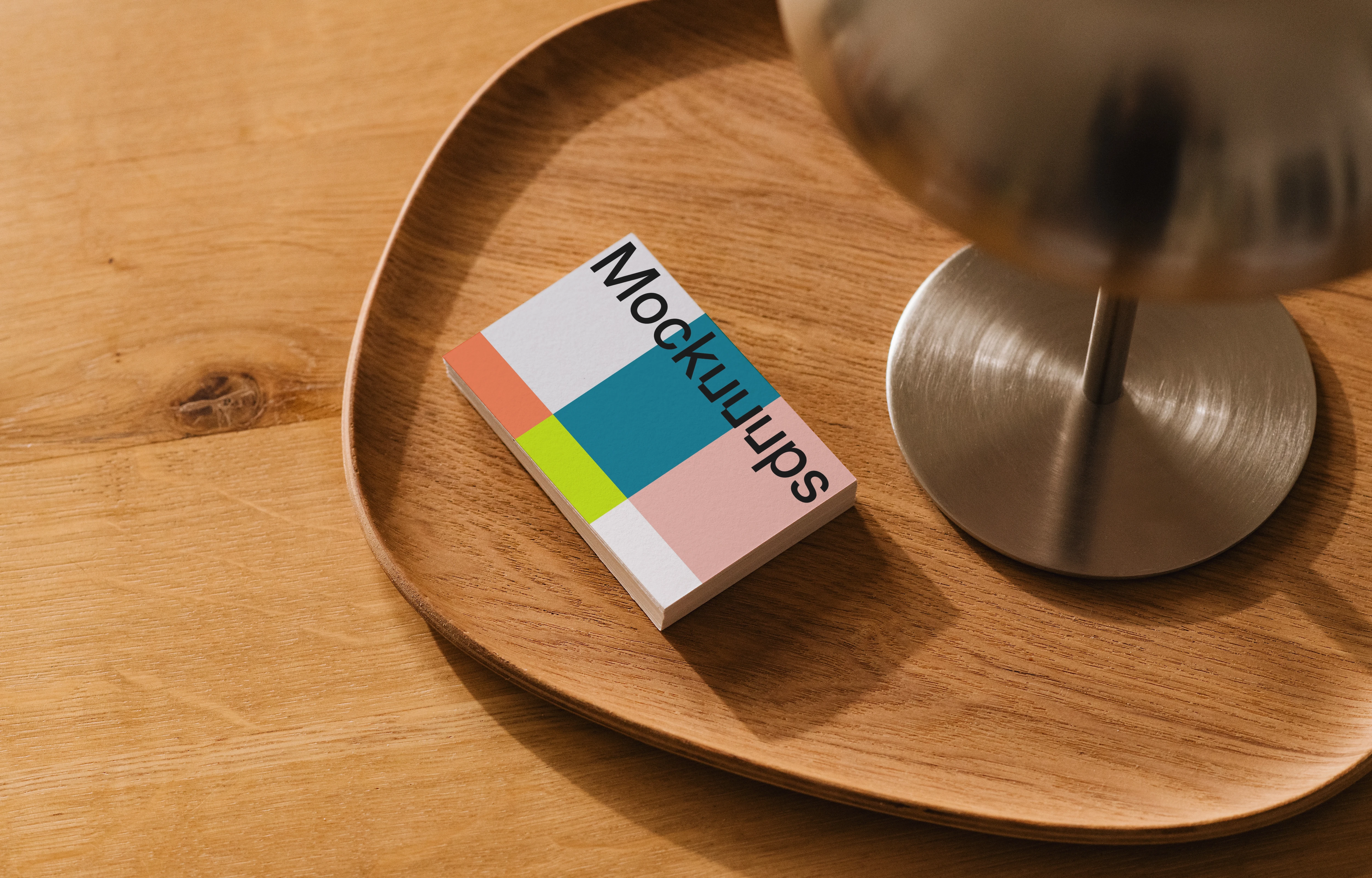 Business card mockup on a wooden tray with lamp
