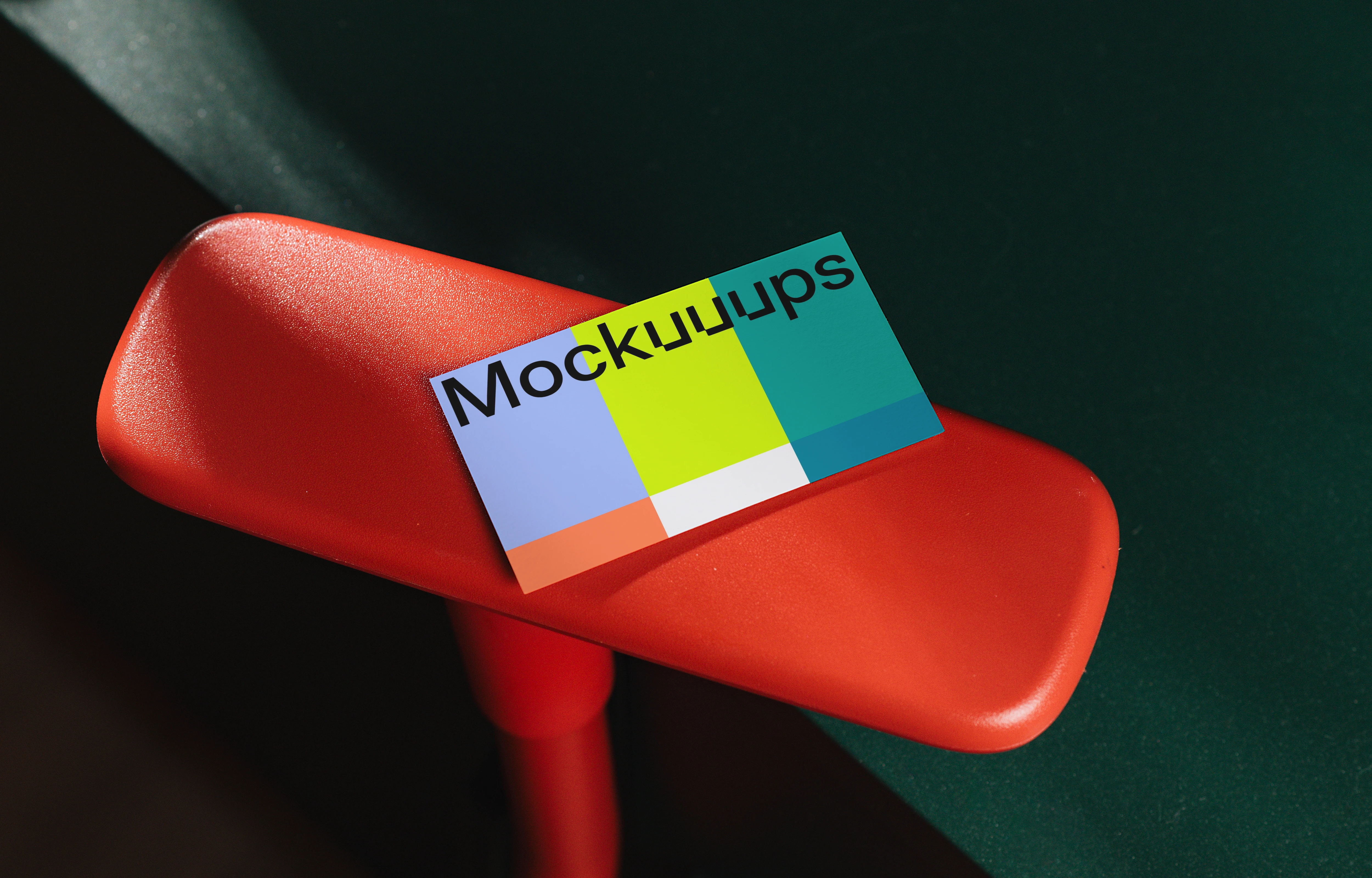 EU business card mockup on red chair armrest
