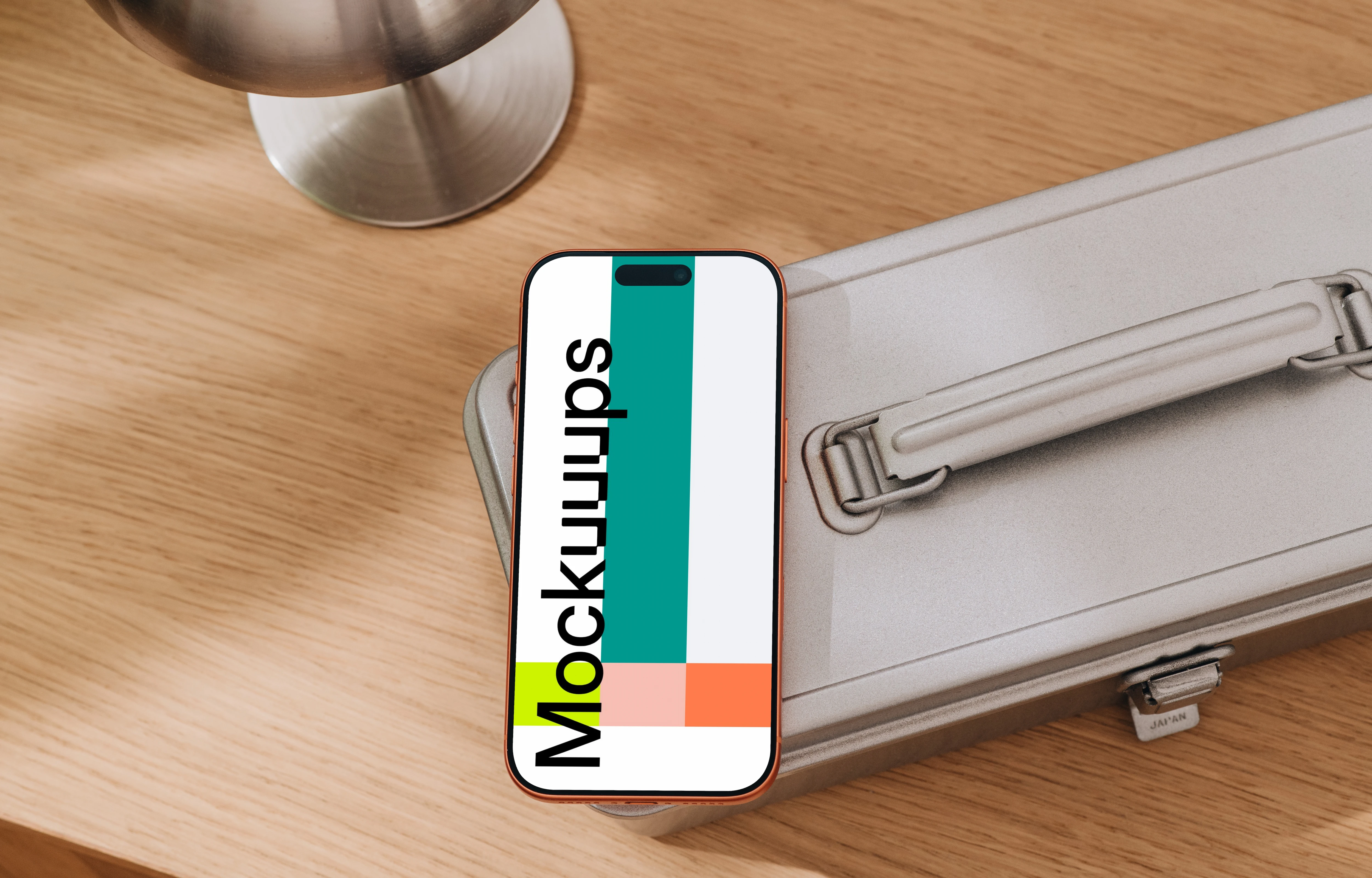 iPhone 17 Pro mockup on a metallic suitcase
