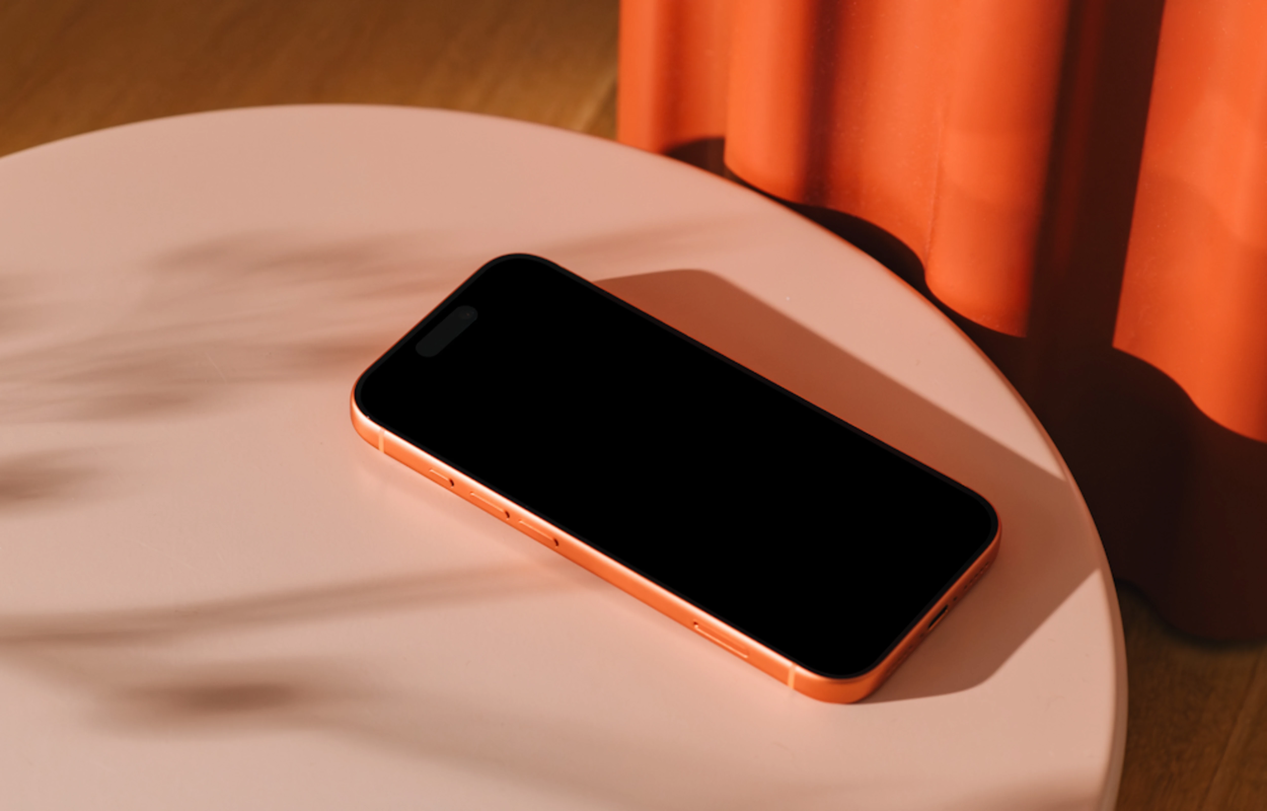 iPhone 17 Pro mockup on a pink round table