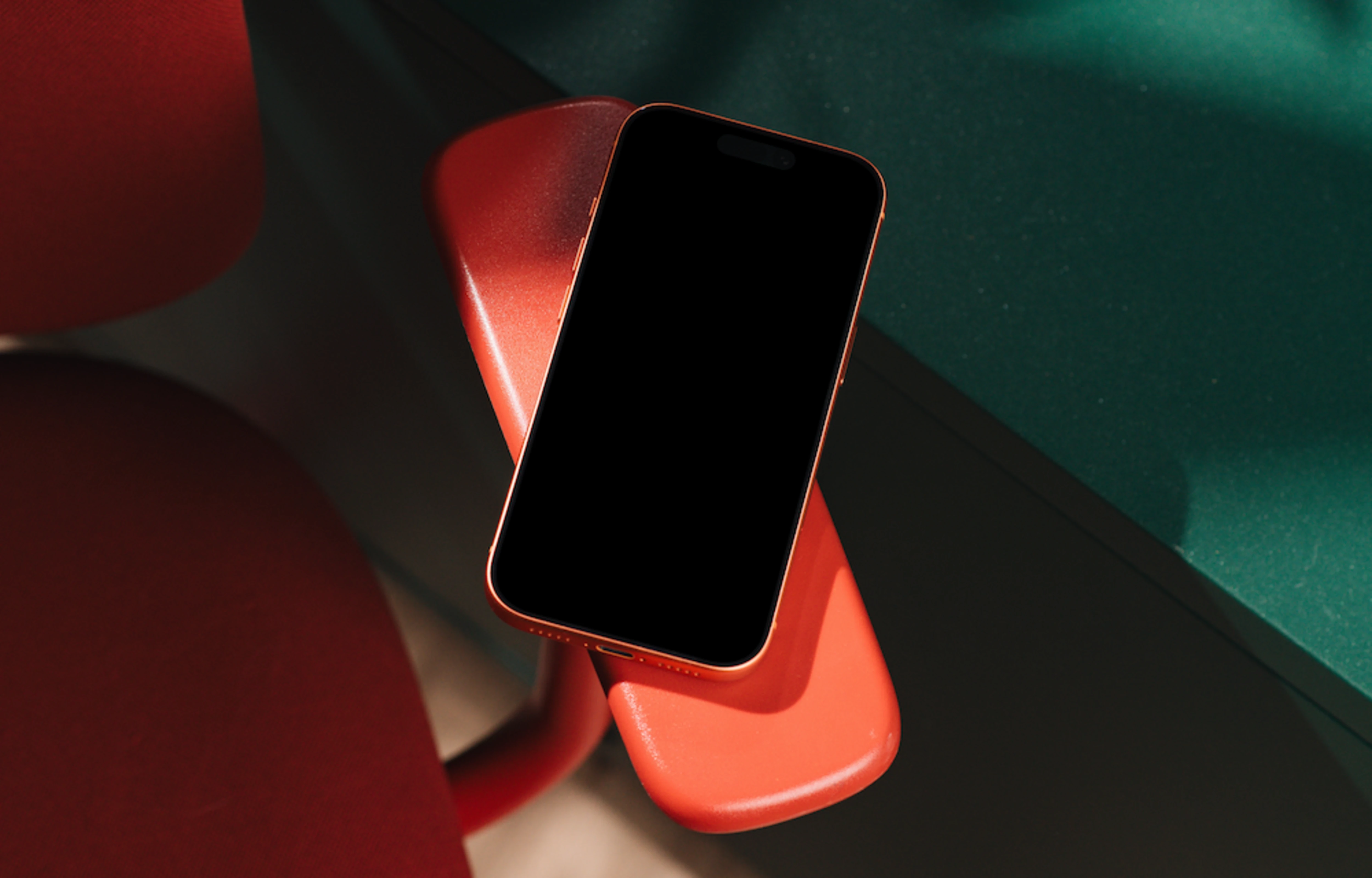 iPhone 17 Pro mockup on a red chair