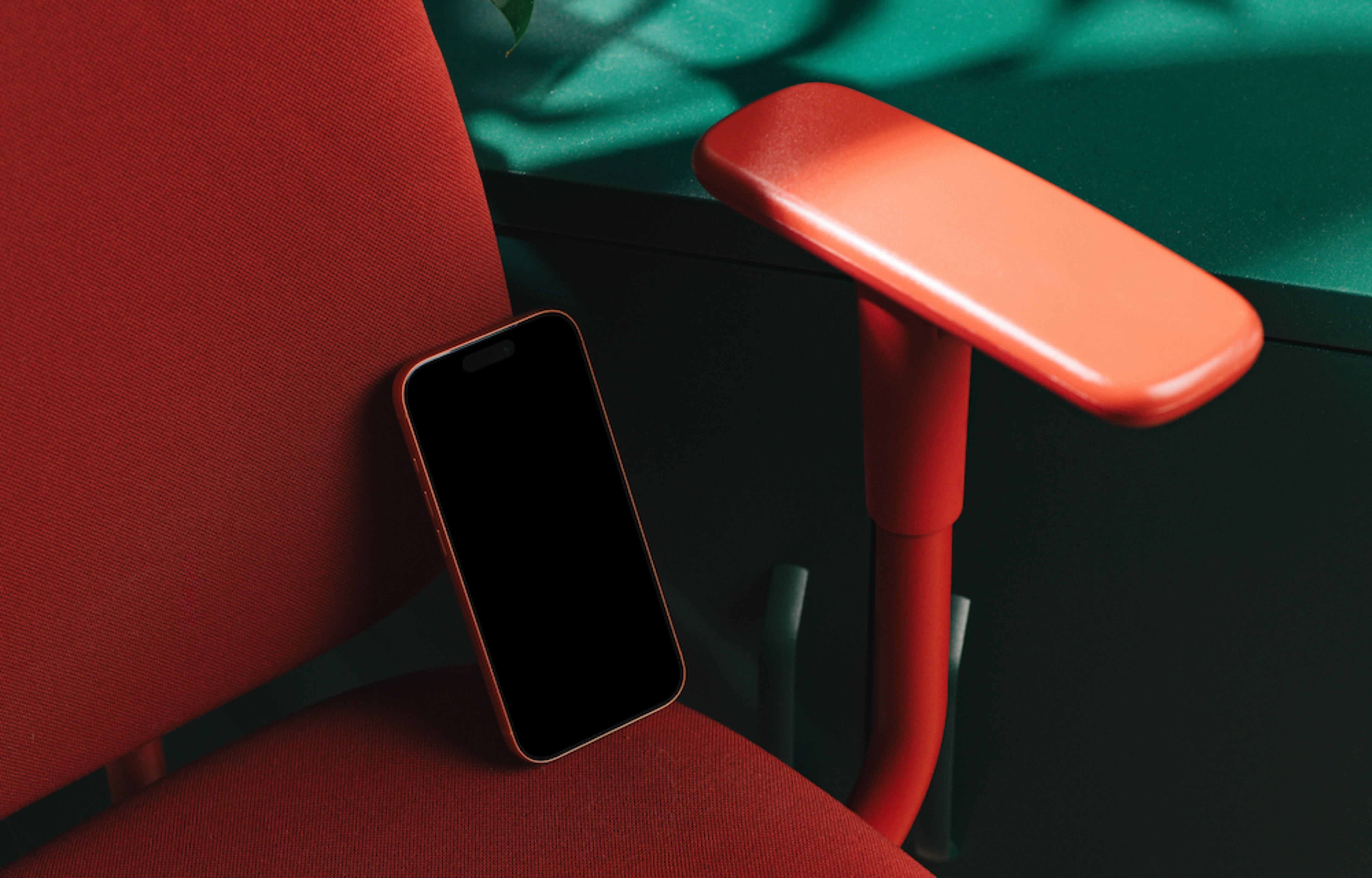 iPhone 17 Pro mockup on a red office chair