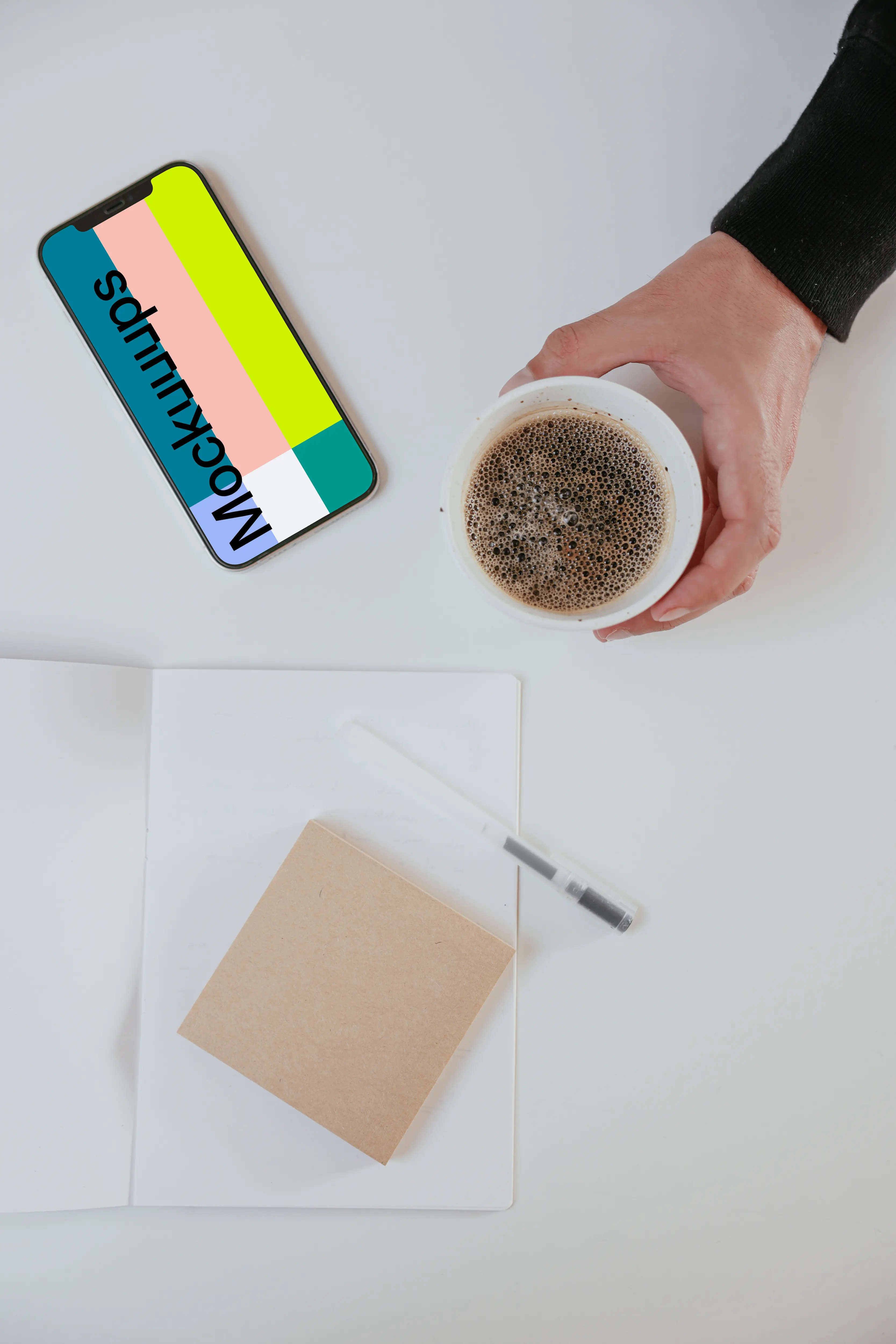 Minimal iPhone mockup on a table with a cup of coffee by the side