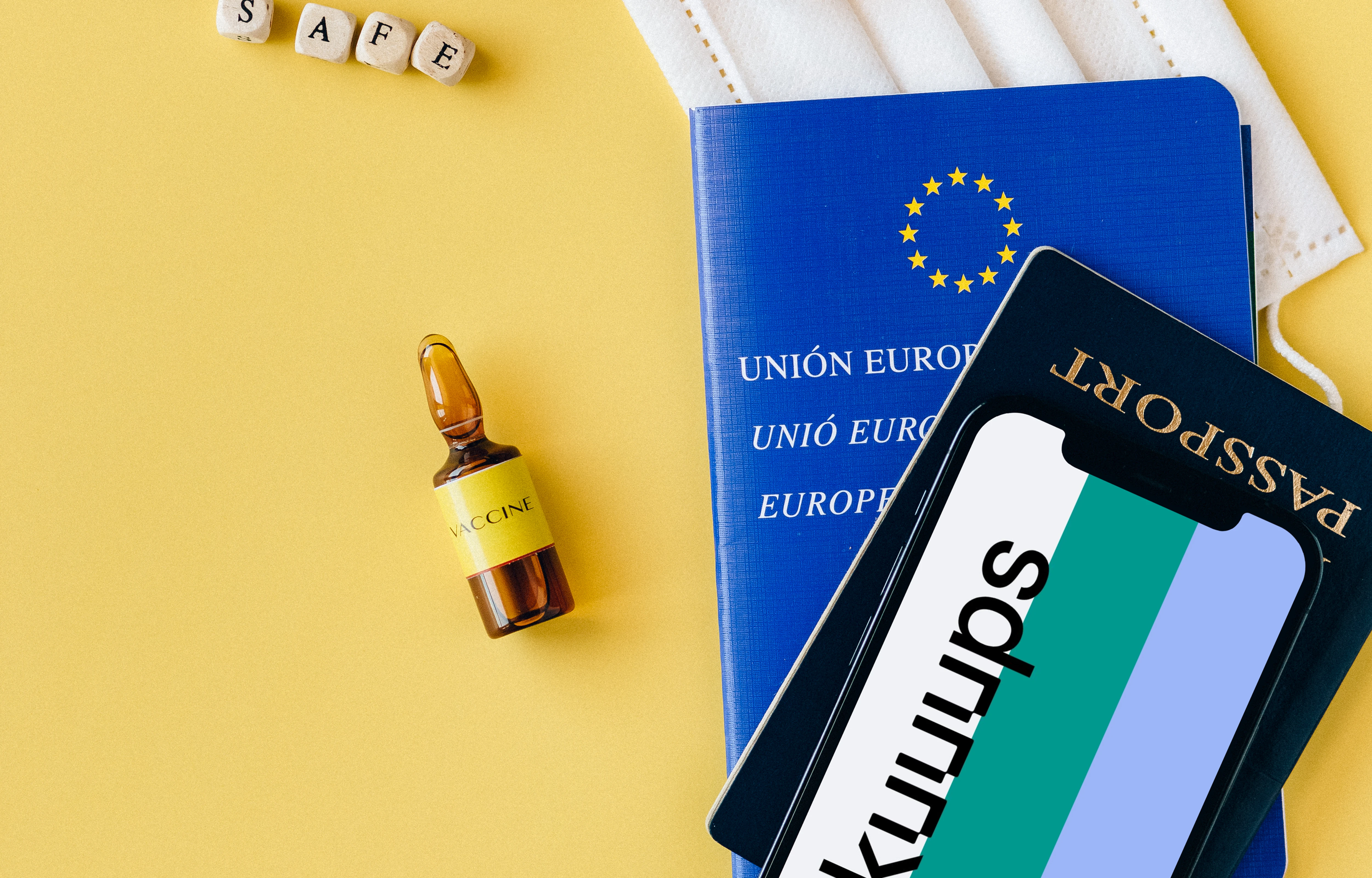iPhone 12 Pro mockup on a passport beside a vial of vaccine