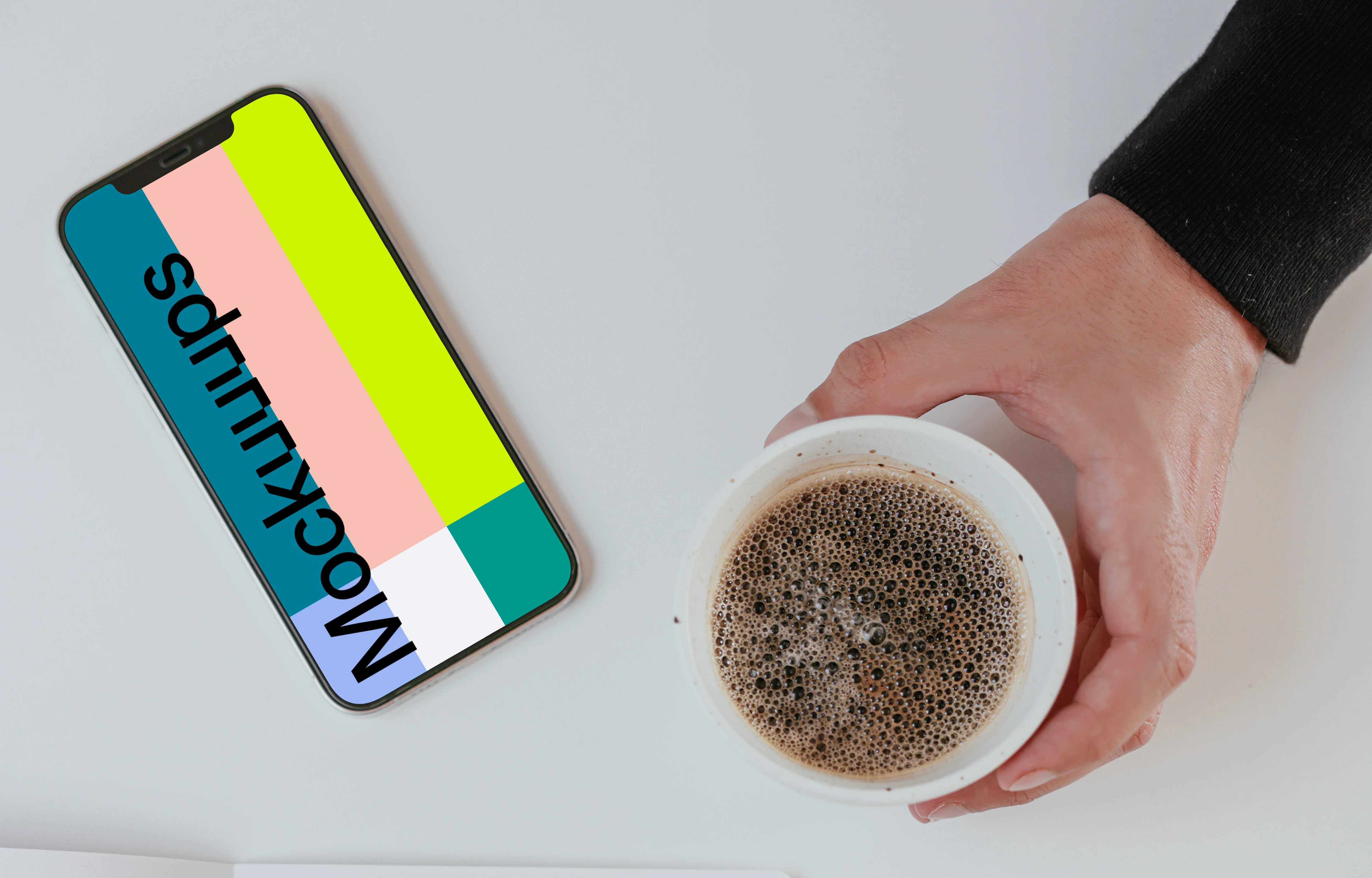 Minimal iPhone mockup on a table with a cup of coffee by the side
