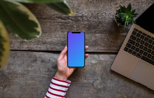 iPhone XS mockup con el Macbook Air de fondo.