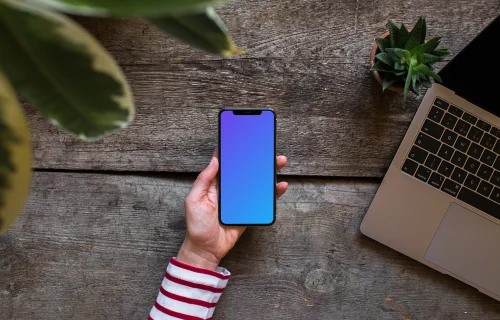 iPhone XS mockup with Macbook Air in the background