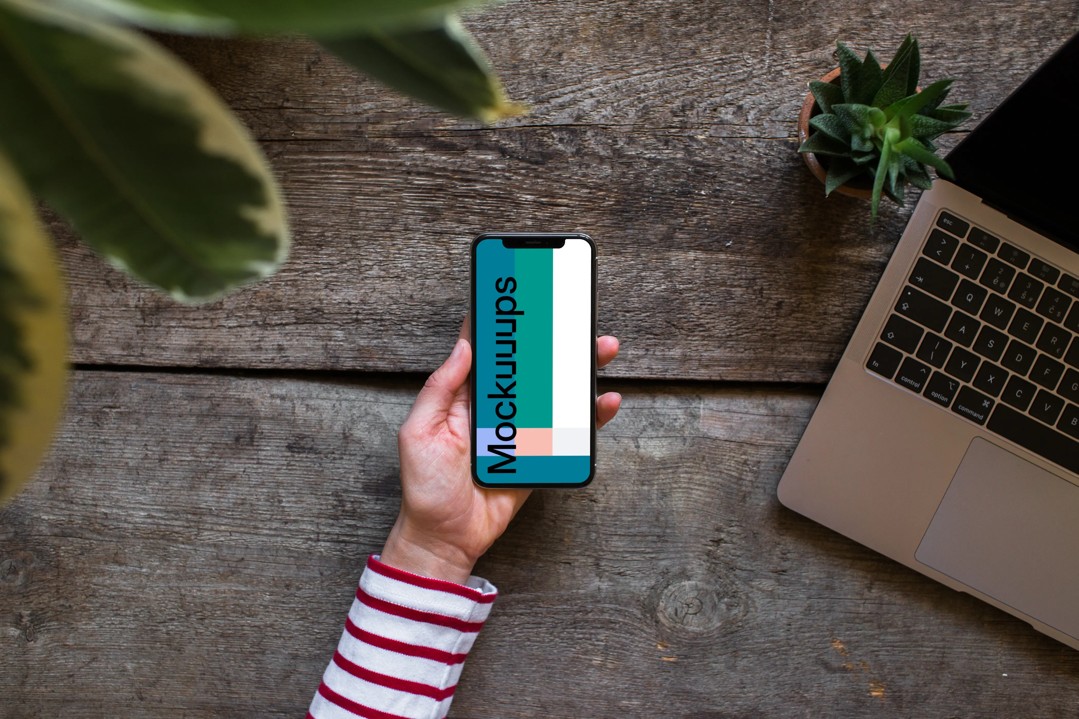 iPhone XS mockup with Macbook Air in the background