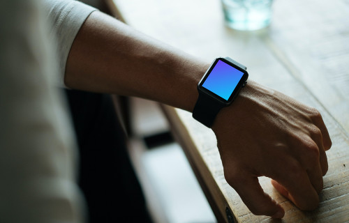 Apple Watch mockup beside glass desk