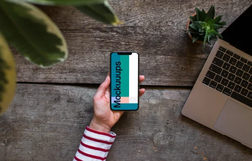 iPhone XS mockup with Macbook Air in the background