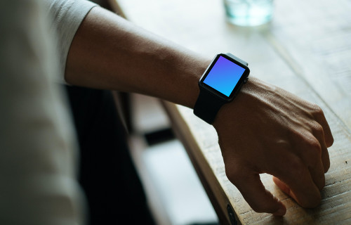 Apple Watch mockup beside glass desk