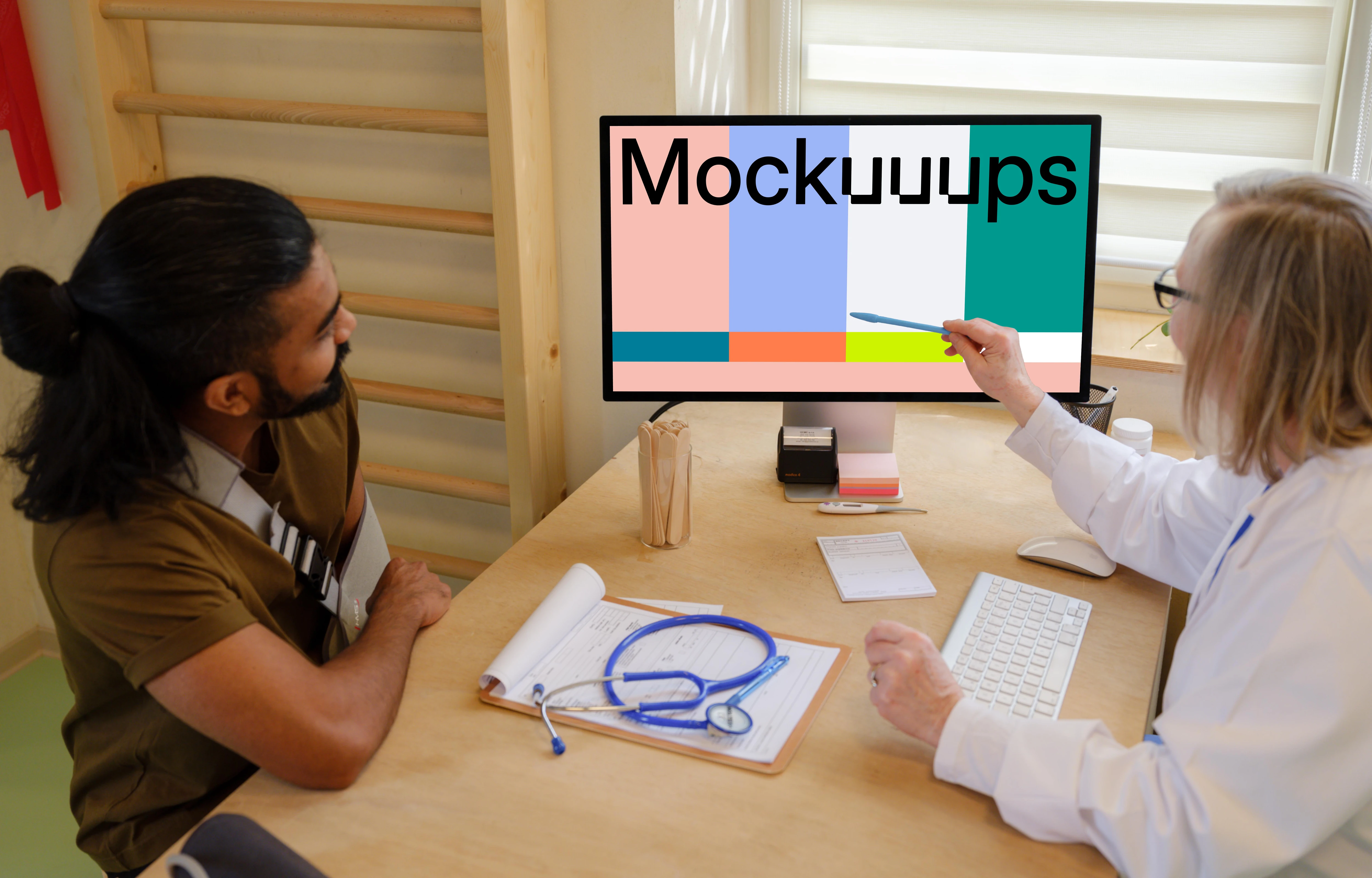 Doctor touches the screen of Apple Studio Display with pen 