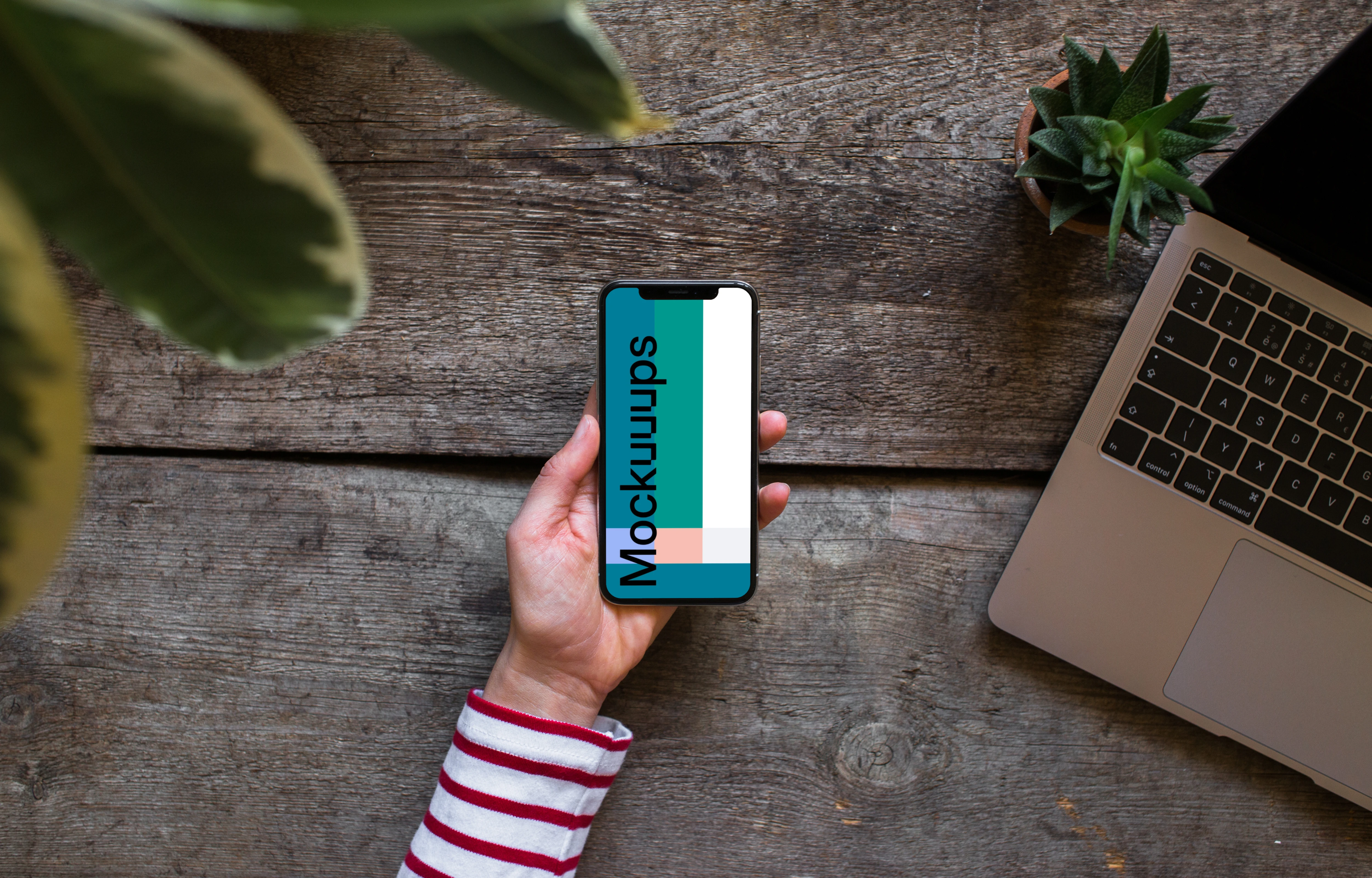 iPhone XS mockup with Macbook Air in the background