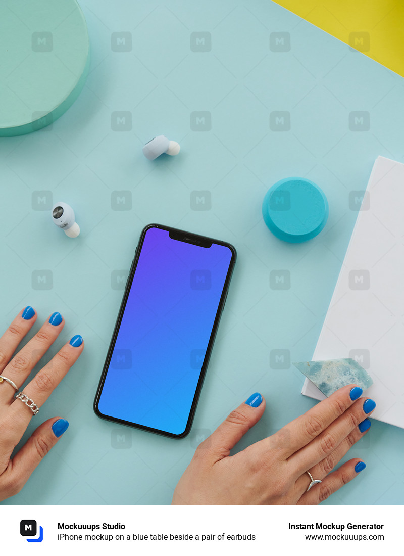  iPhone mockup on a blue table beside a pair of earbuds