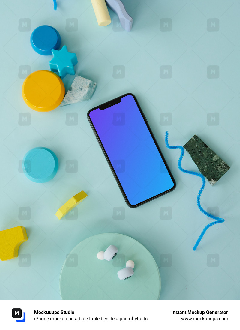 iPhone mockup on a blue table beside a pair of ebuds