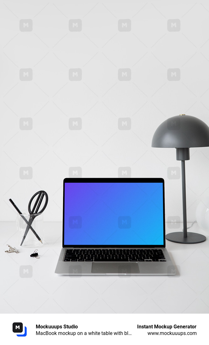 MacBook mockup on a white table with black table lamp at the side