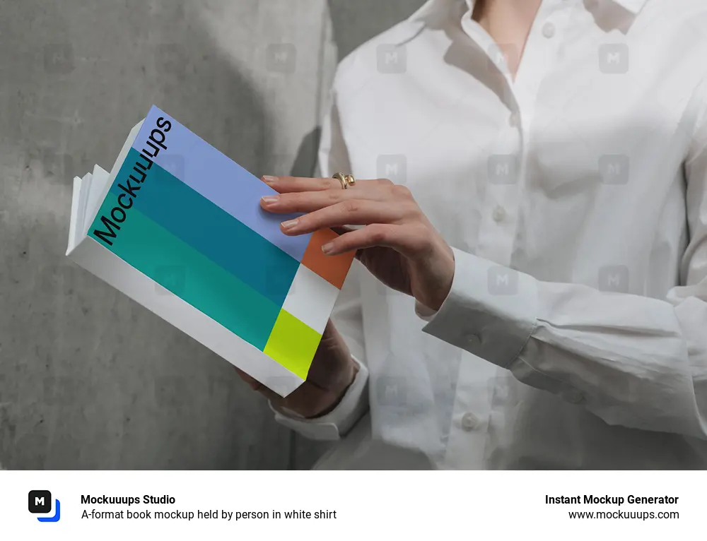 A-format book mockup held by person in white shirt