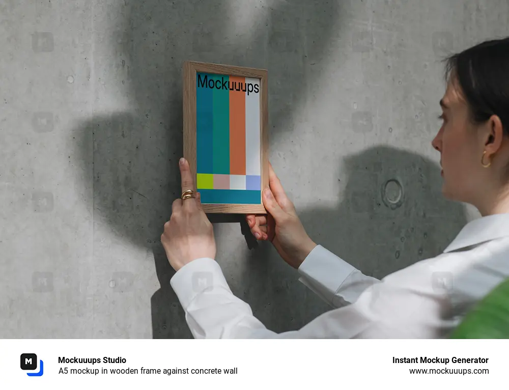 A5 mockup in wooden frame against concrete wall