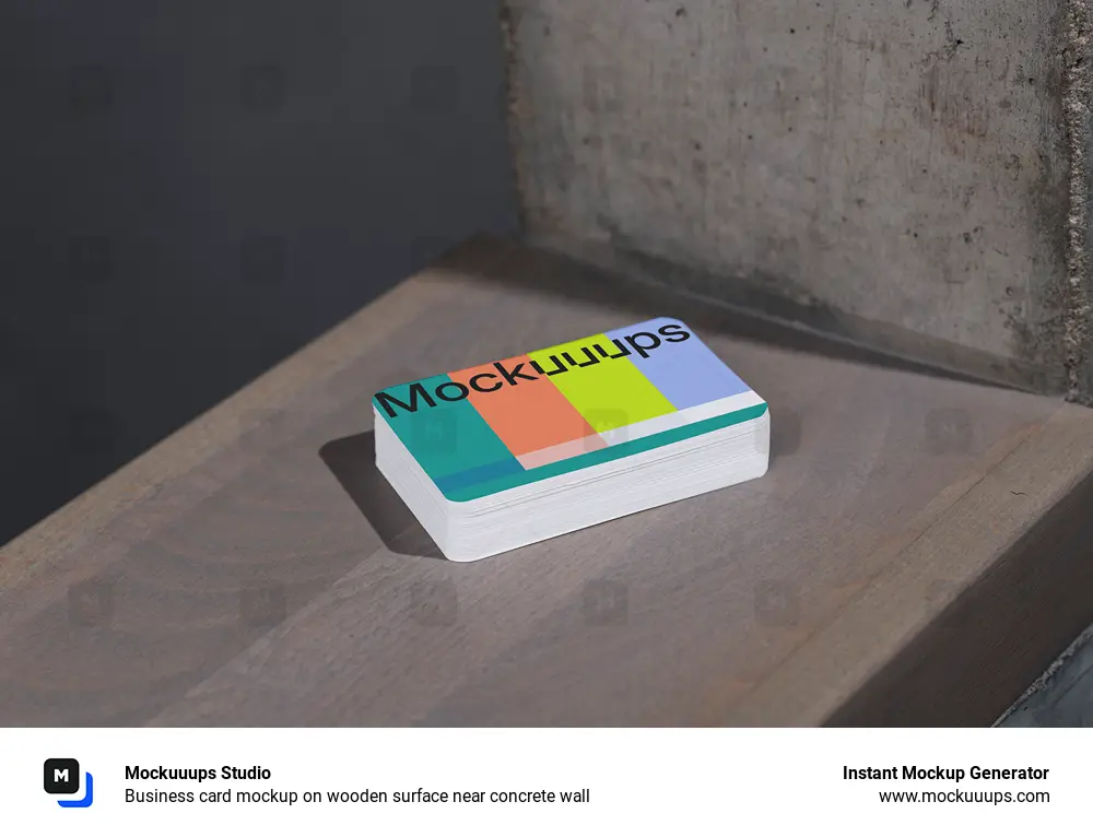 Business card mockup on wooden surface near concrete wall
