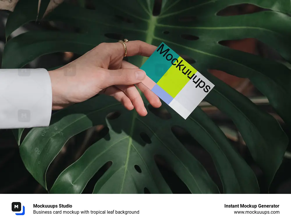 Business card mockup with tropical leaf background