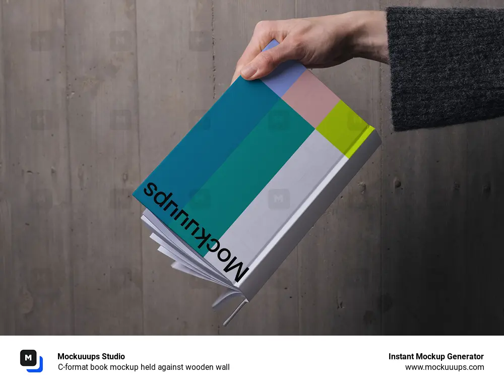 C-format book mockup held against wooden wall