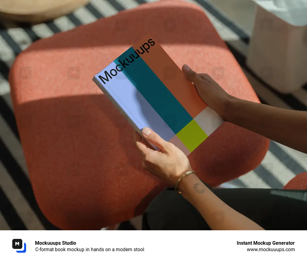 C-format book mockup in hands on a modern stool