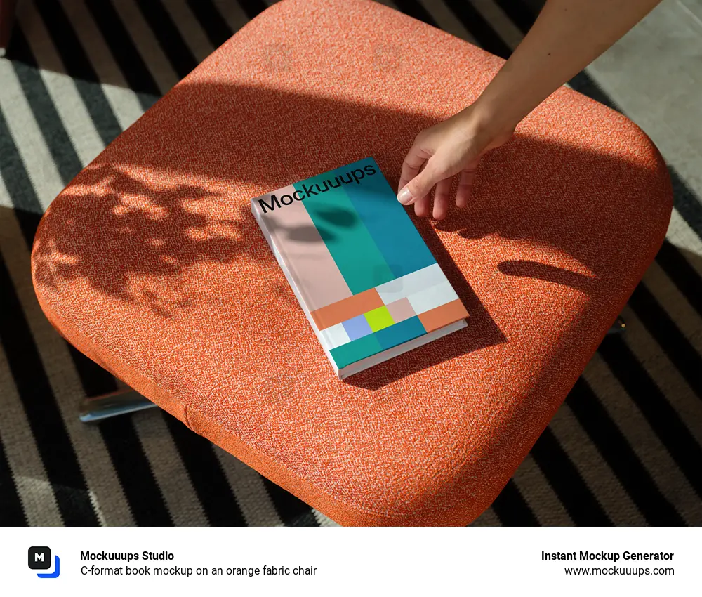 C-format book mockup on an orange fabric chair