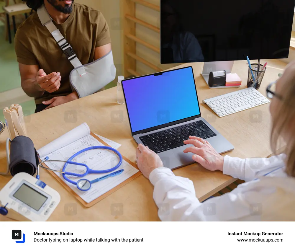 Doctor typing on laptop while talking with the patient