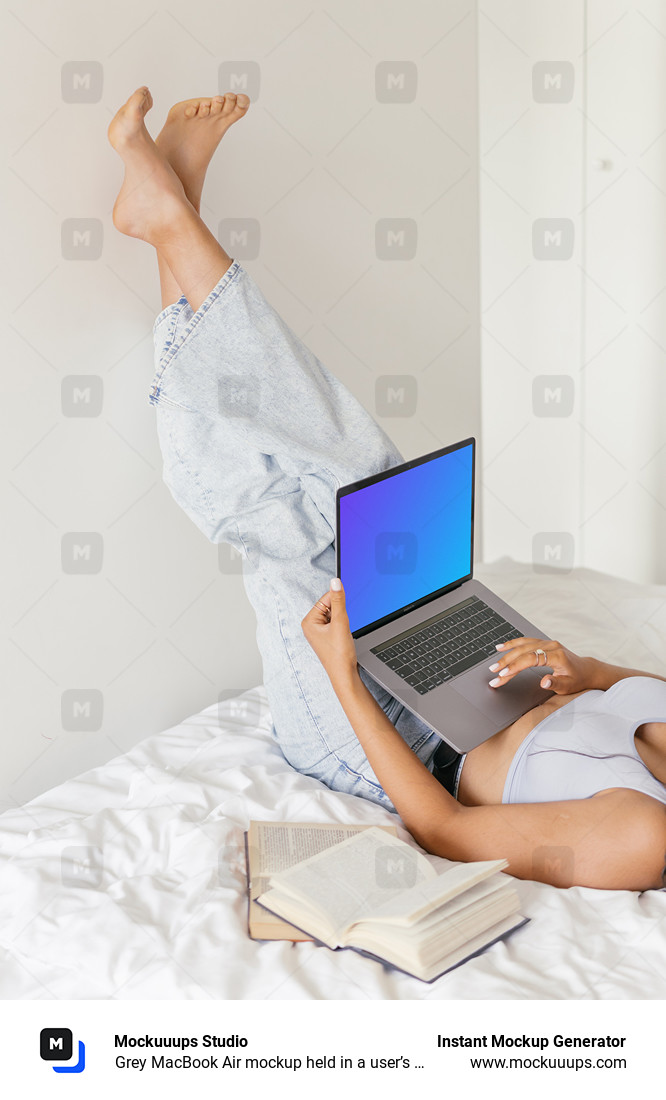 Grey MacBook Air mockup held in a user’s lap
