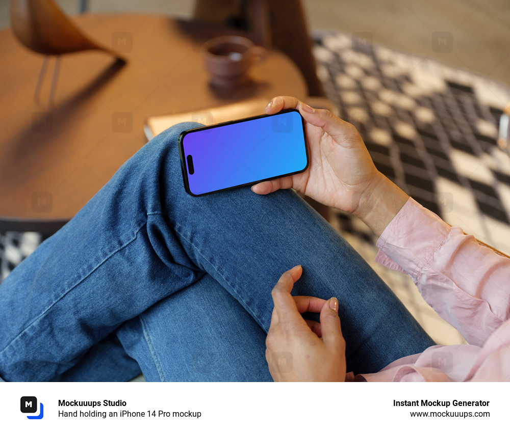 Hand holding an iPhone 14 Pro mockup