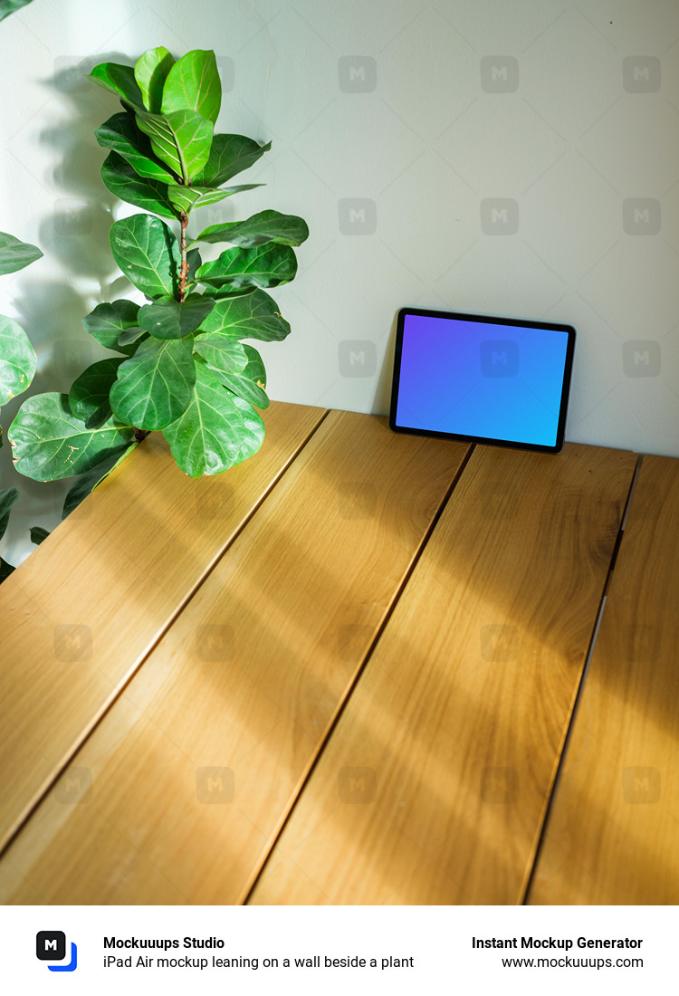 iPad Air mockup leaning on a wall beside a plant