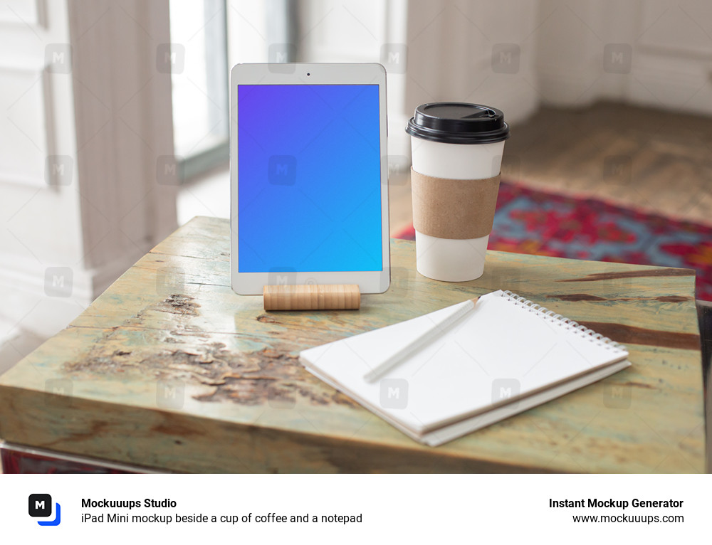  iPad Mini mockup beside a cup of coffee and a notepad