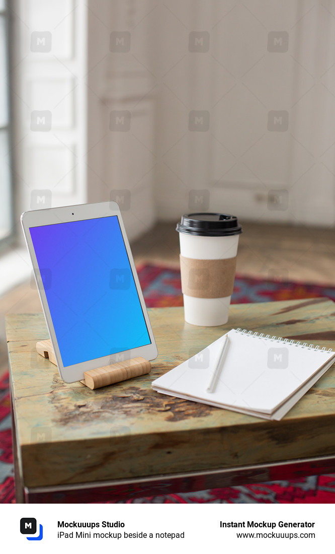 iPad Mini mockup beside a notepad