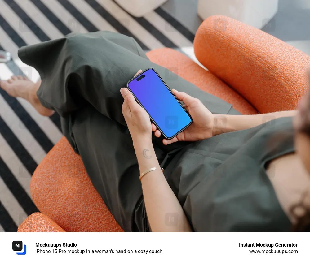 iPhone 15 Pro mockup in a woman's hand on a cozy couch