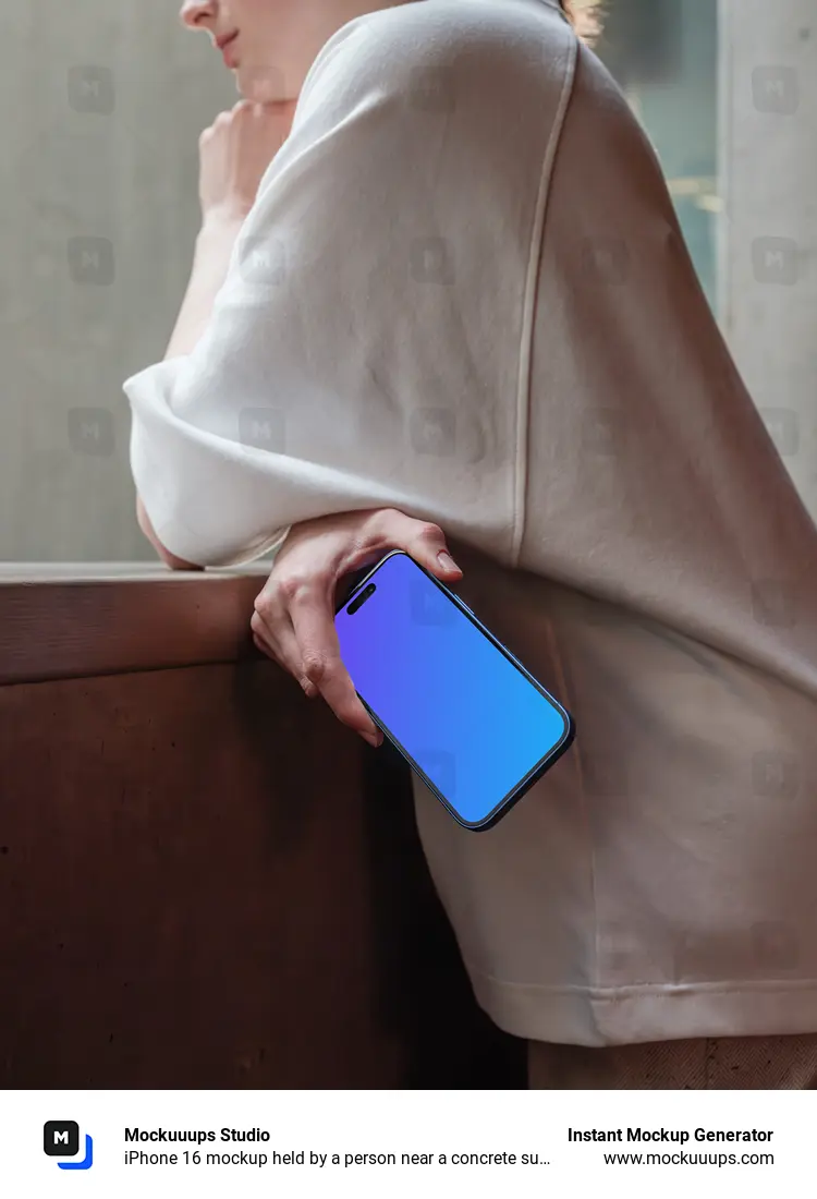 iPhone 16 mockup held by a person near a concrete surface